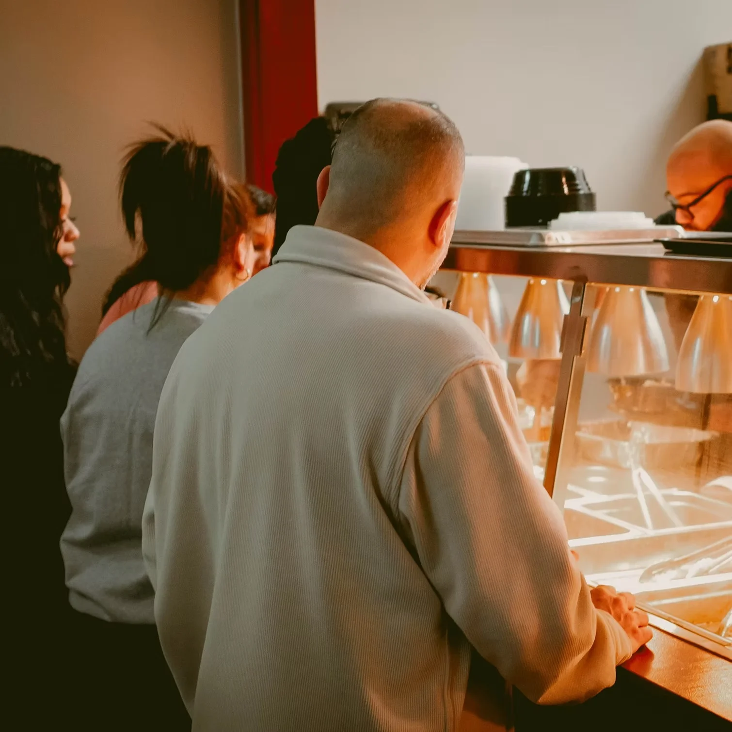 Customers waiting in line at a casual restaurant counter