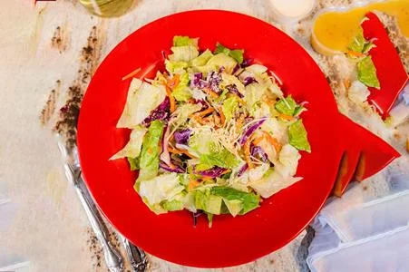 Fresh garden salad served in a vibrant red bowl