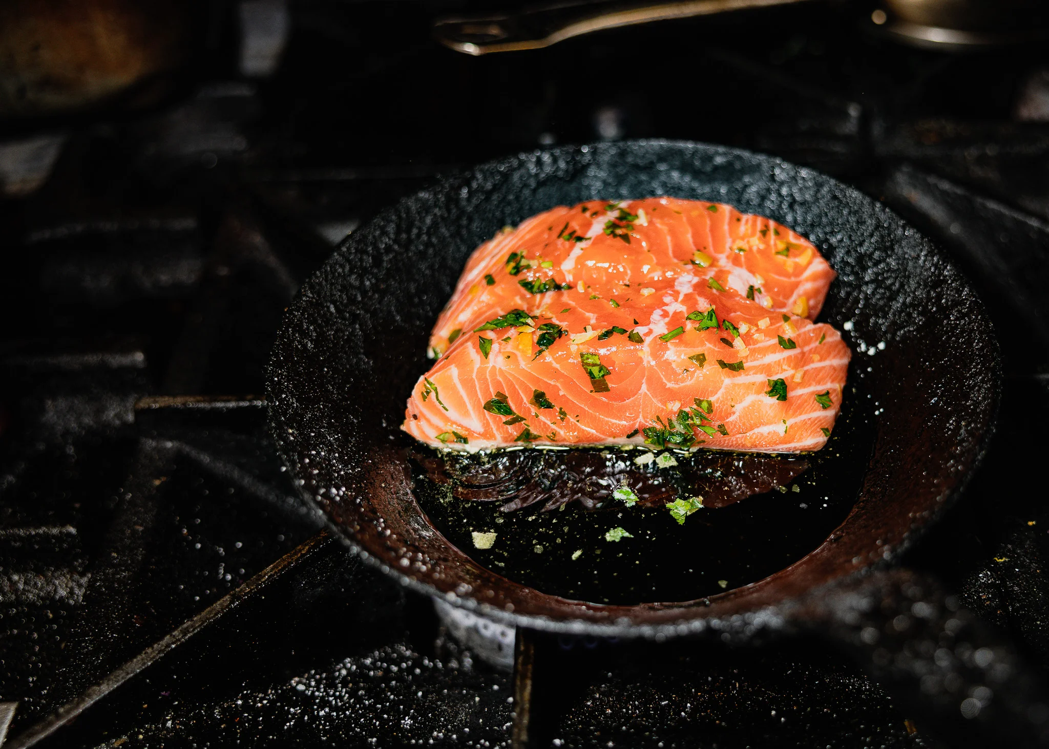 Pan-seared salmon fillets garnished with herbs