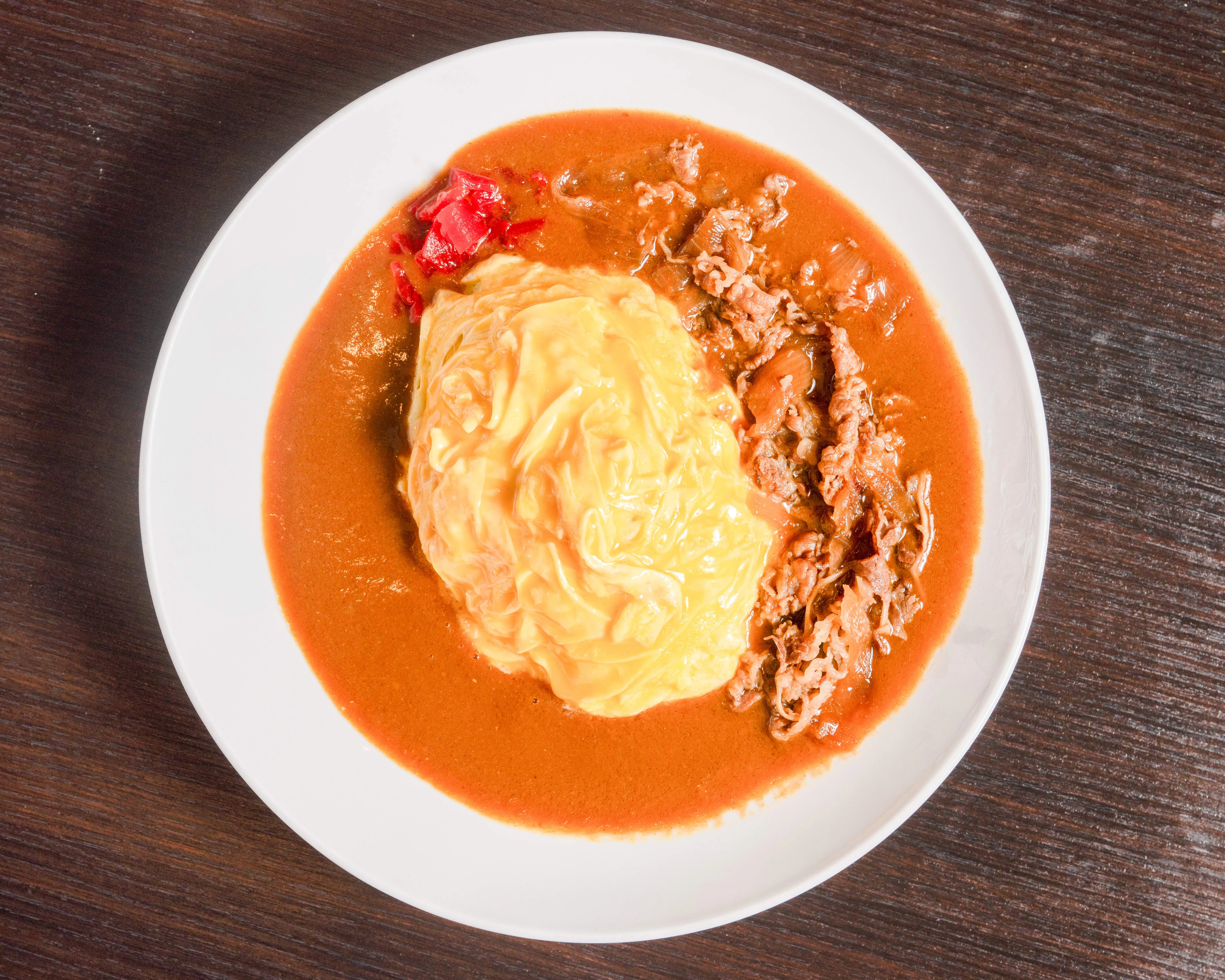 Japanese omurice with savory sauce and shredded beef