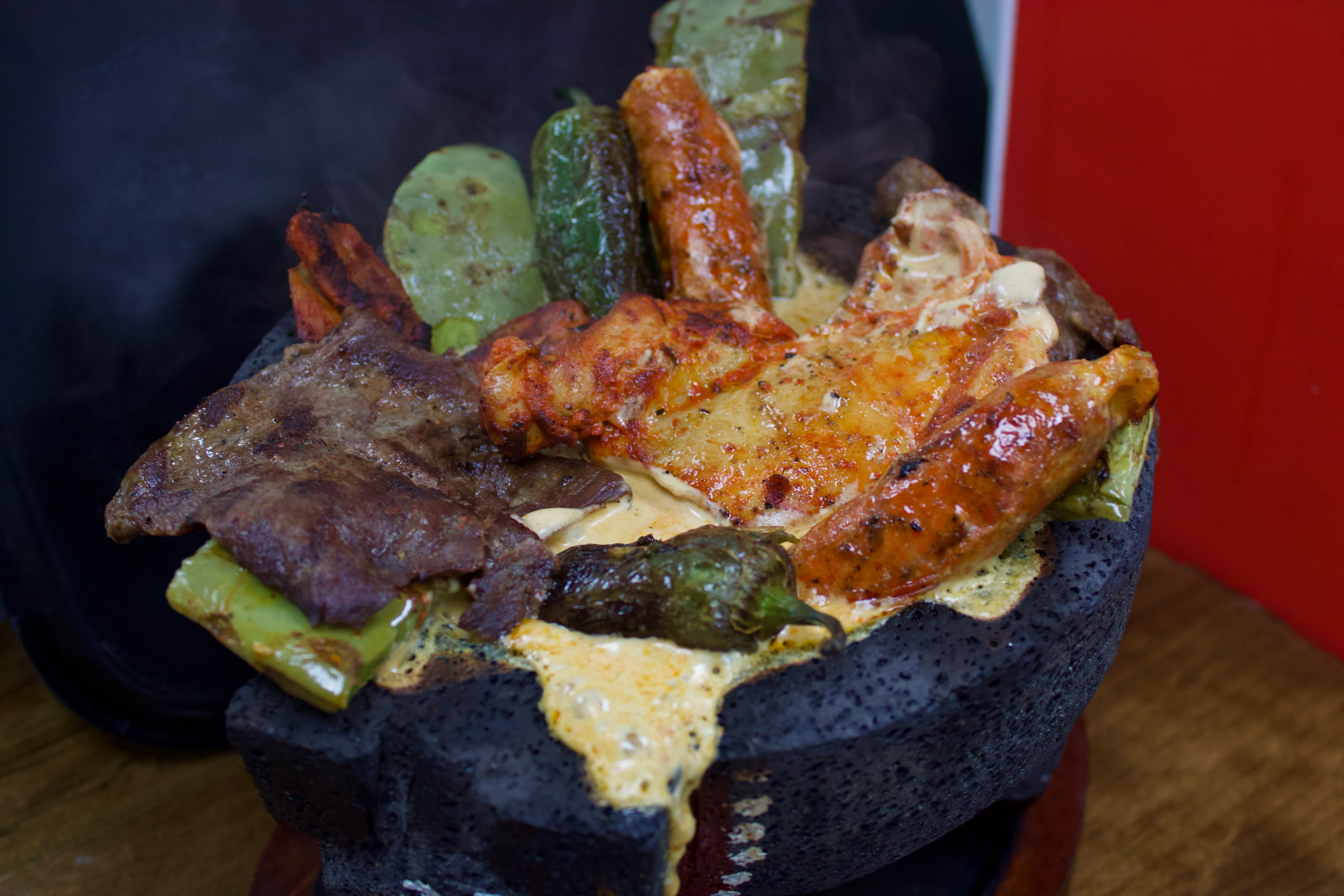 Sizzling Mexican fajitas served in a stone bowl