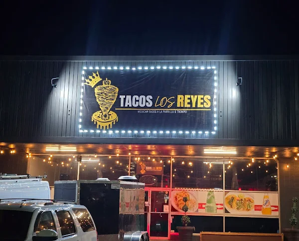 Exterior of Tacos Los Reyes restaurant with illuminated signage