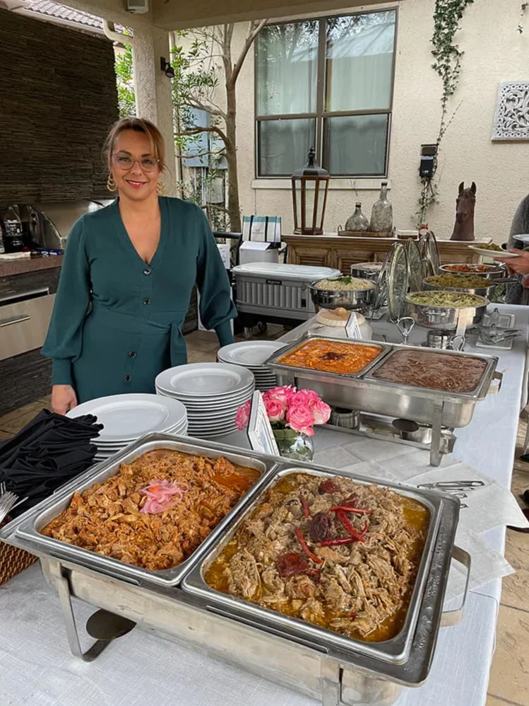 Catering spread featuring Mexican carnitas and sides