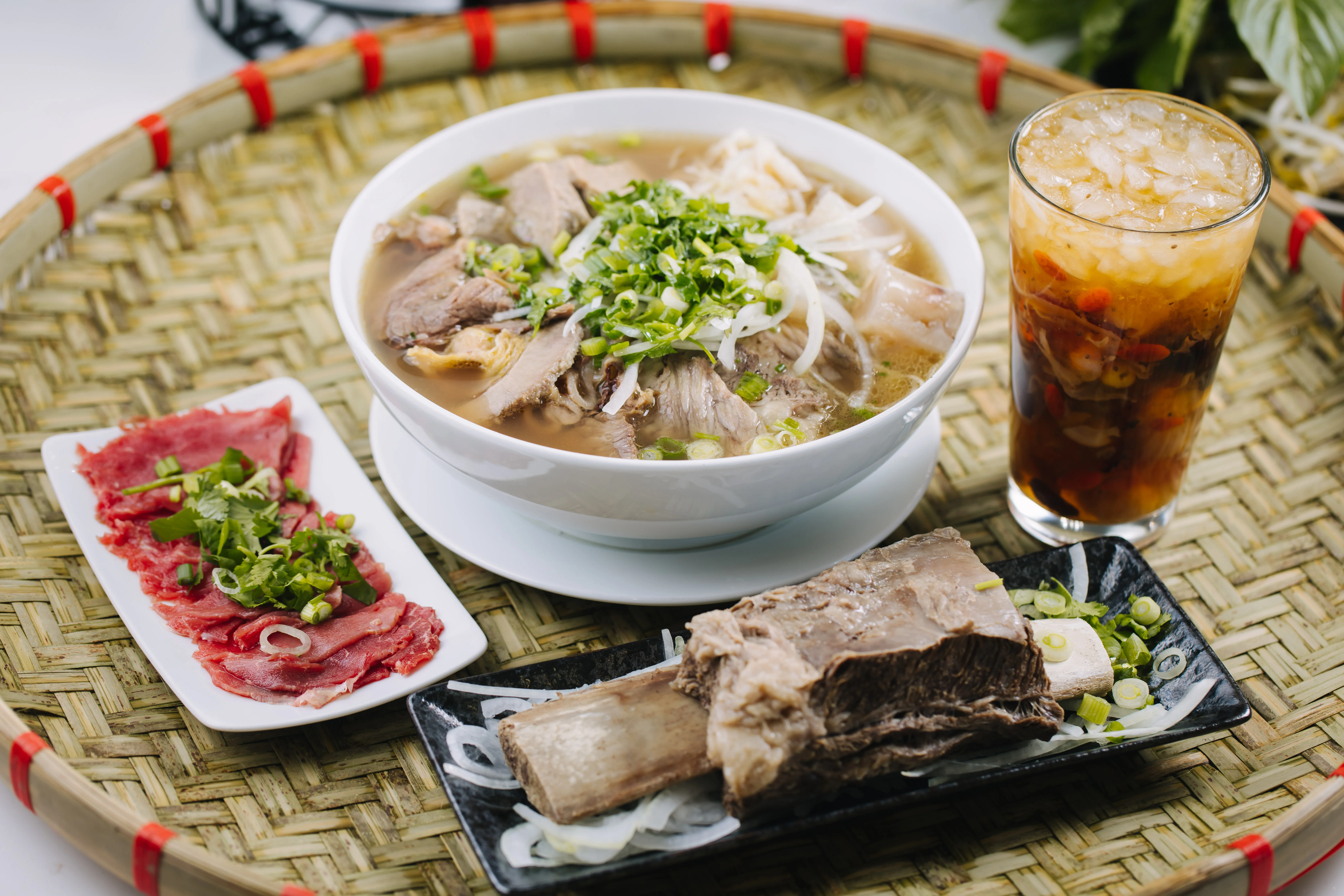 Bowl of Vietnamese pho with beef and fresh herbs