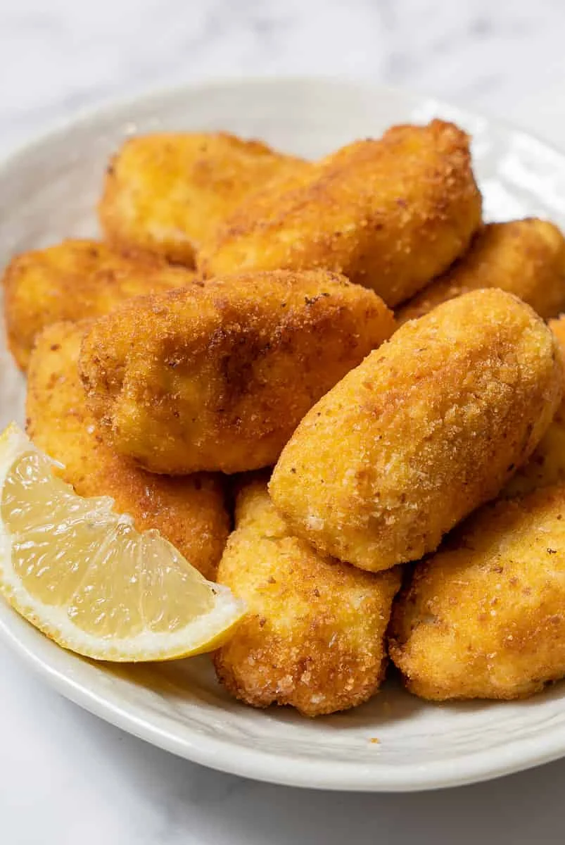 Crispy Colombian arepas de huevo served with lemon