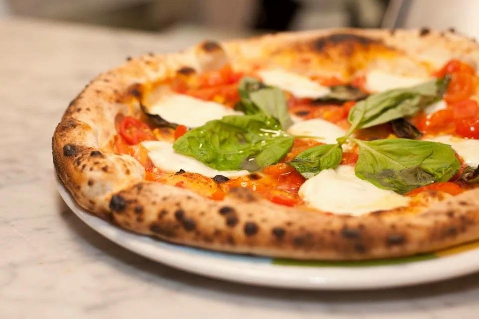 Margherita pizza with fresh basil and mozzarella