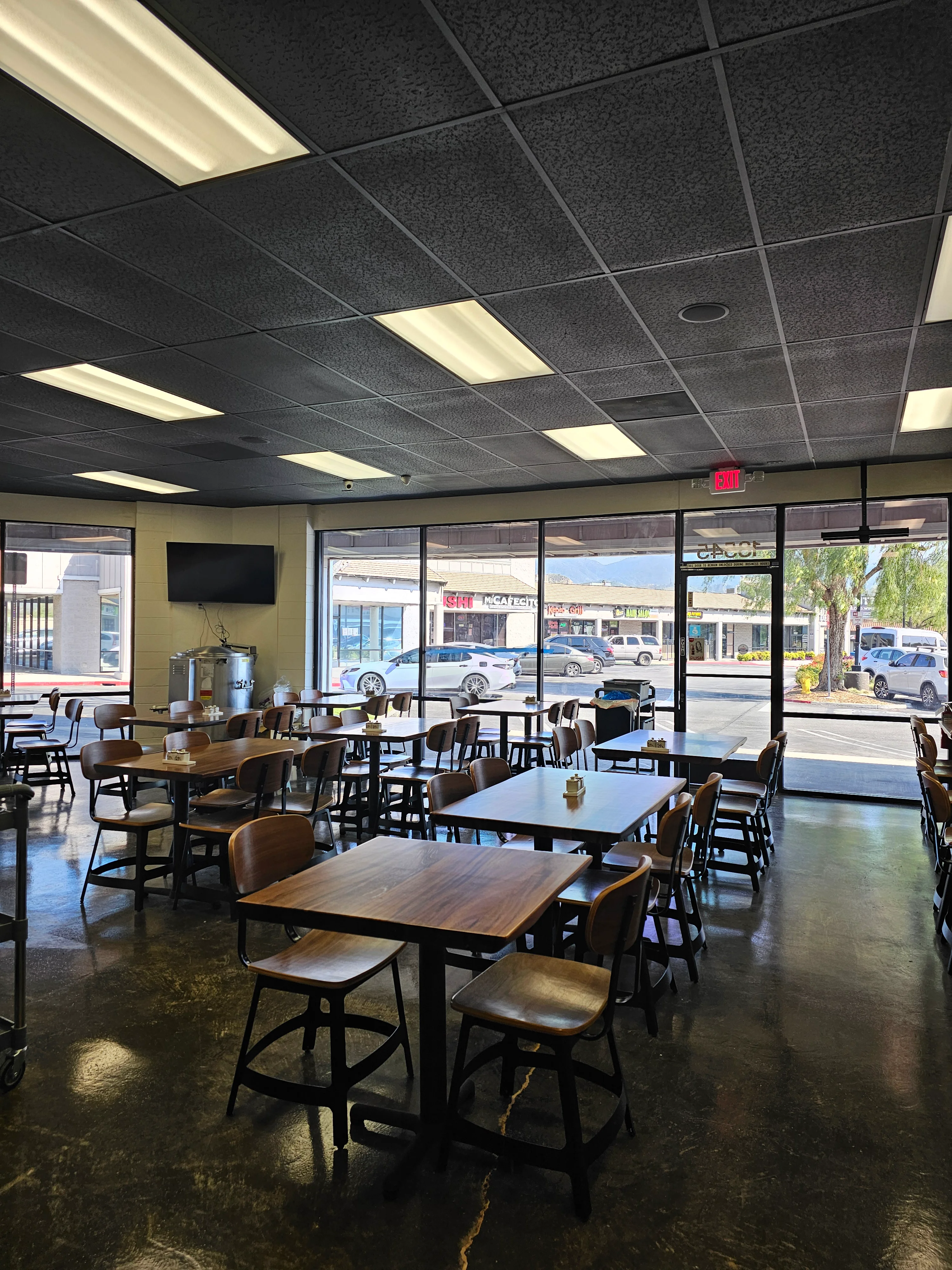 Spacious restaurant interior with modern decor and large windows