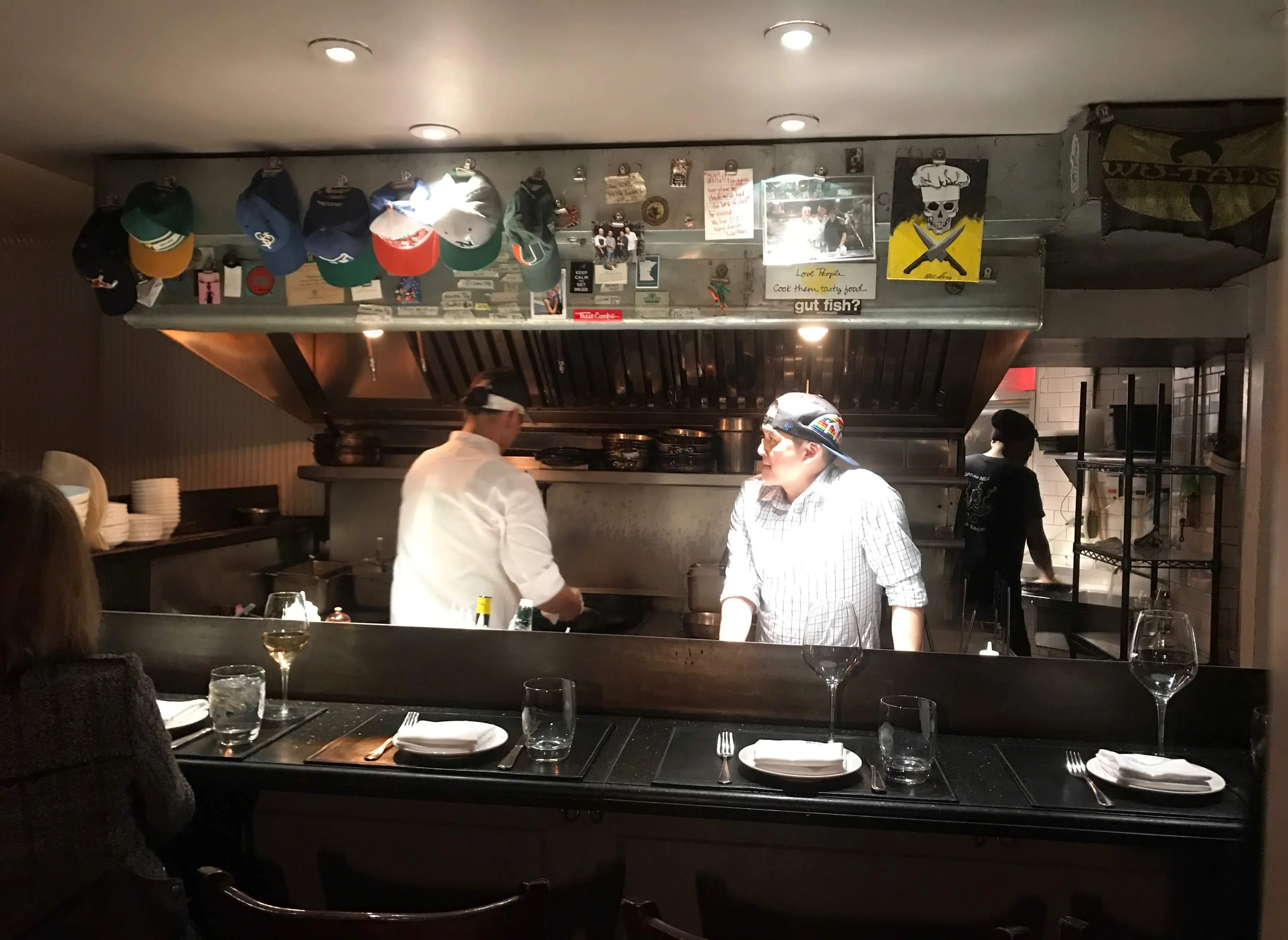 Chefs preparing dishes in a cozy restaurant kitchen