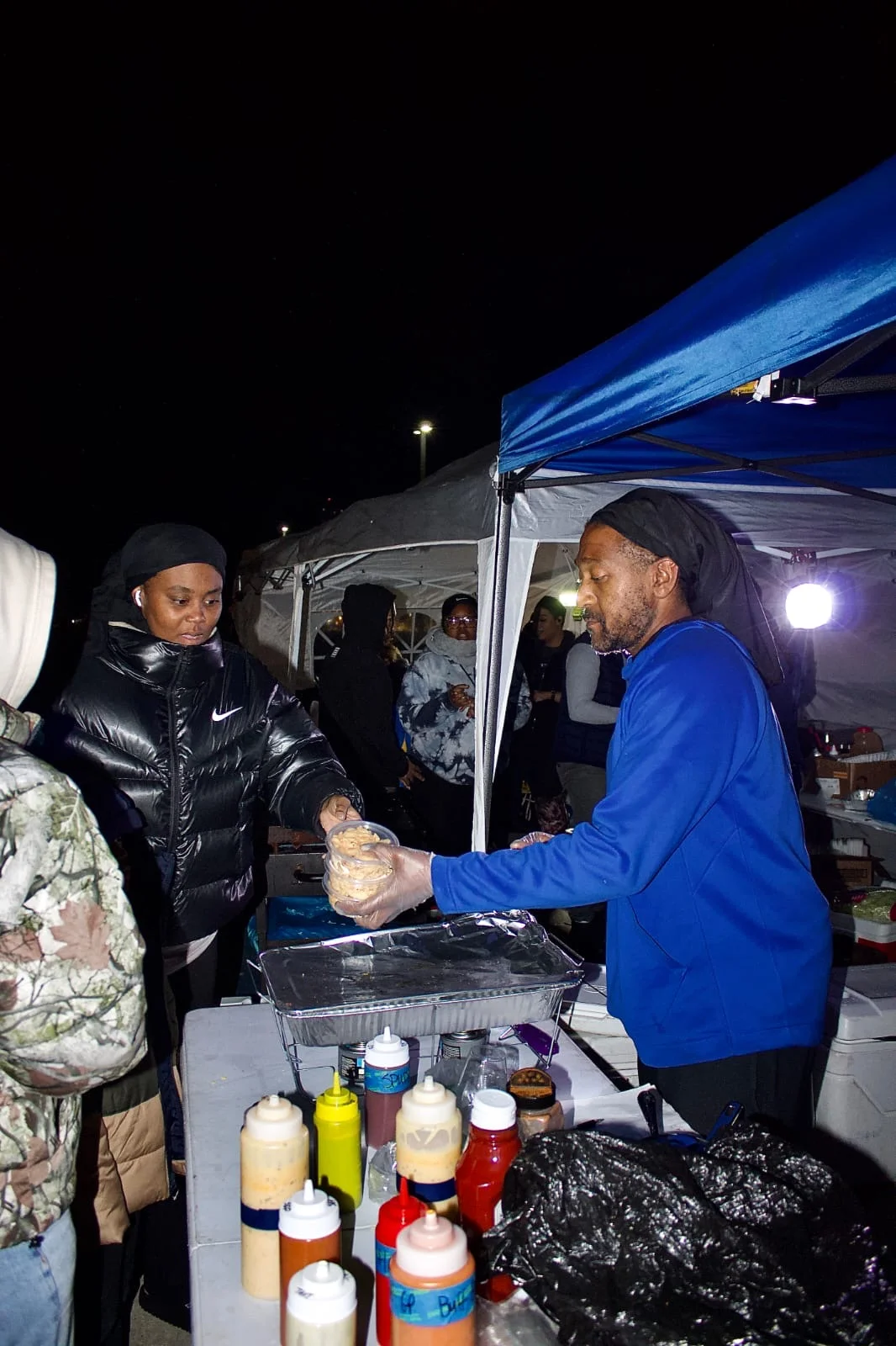 Itean Dozier supplying his craft to happy customers under the blue tent