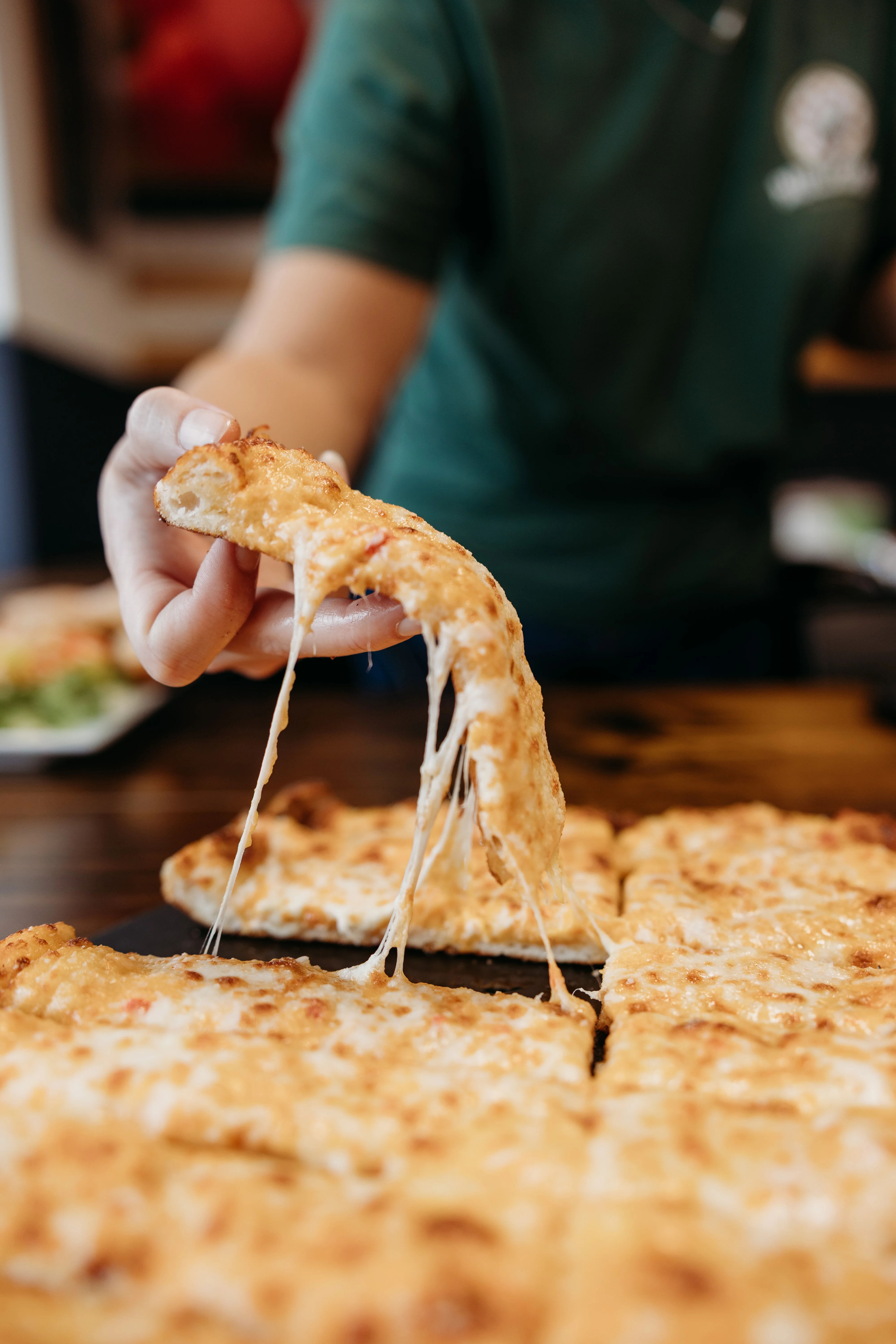 Cheesy New York-style pizza slice with gooey mozzarella