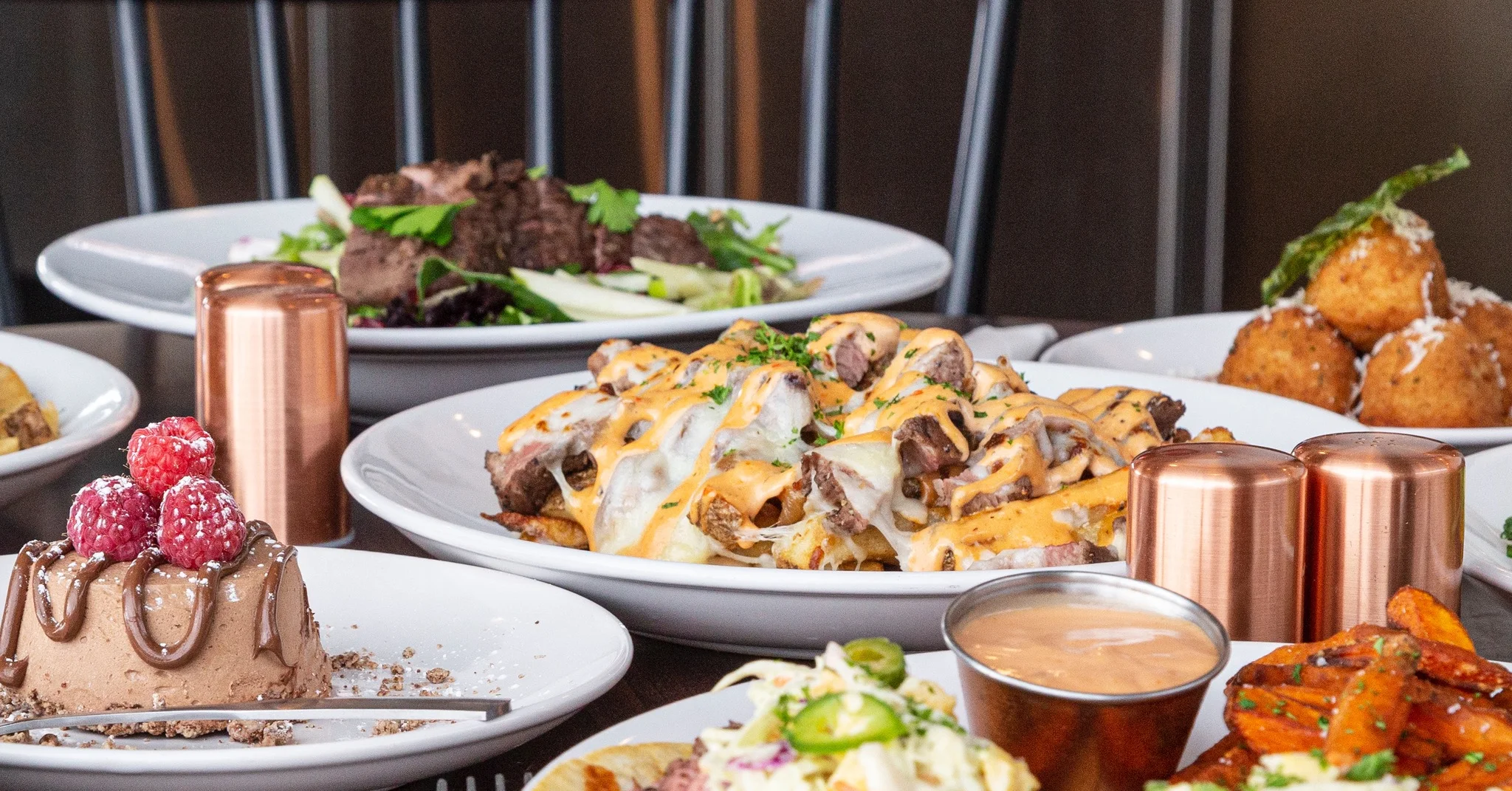 Platter of loaded nachos with cheese and steak
