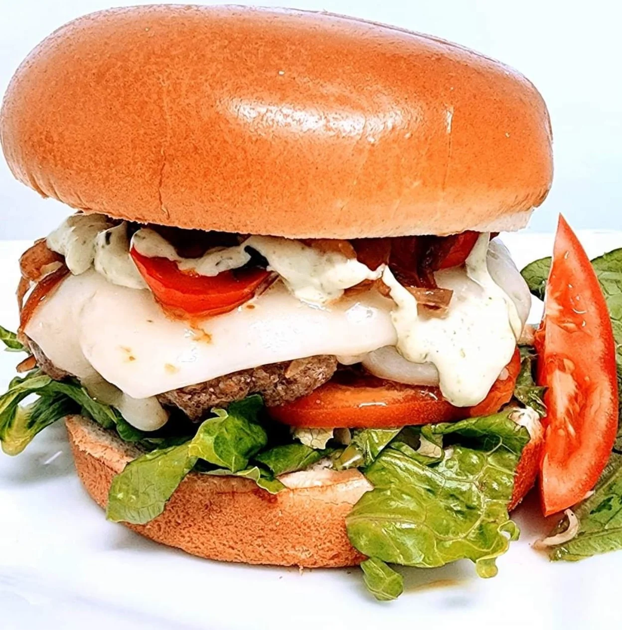 Juicy cheeseburger with fresh lettuce and tomato, classic American comfort food