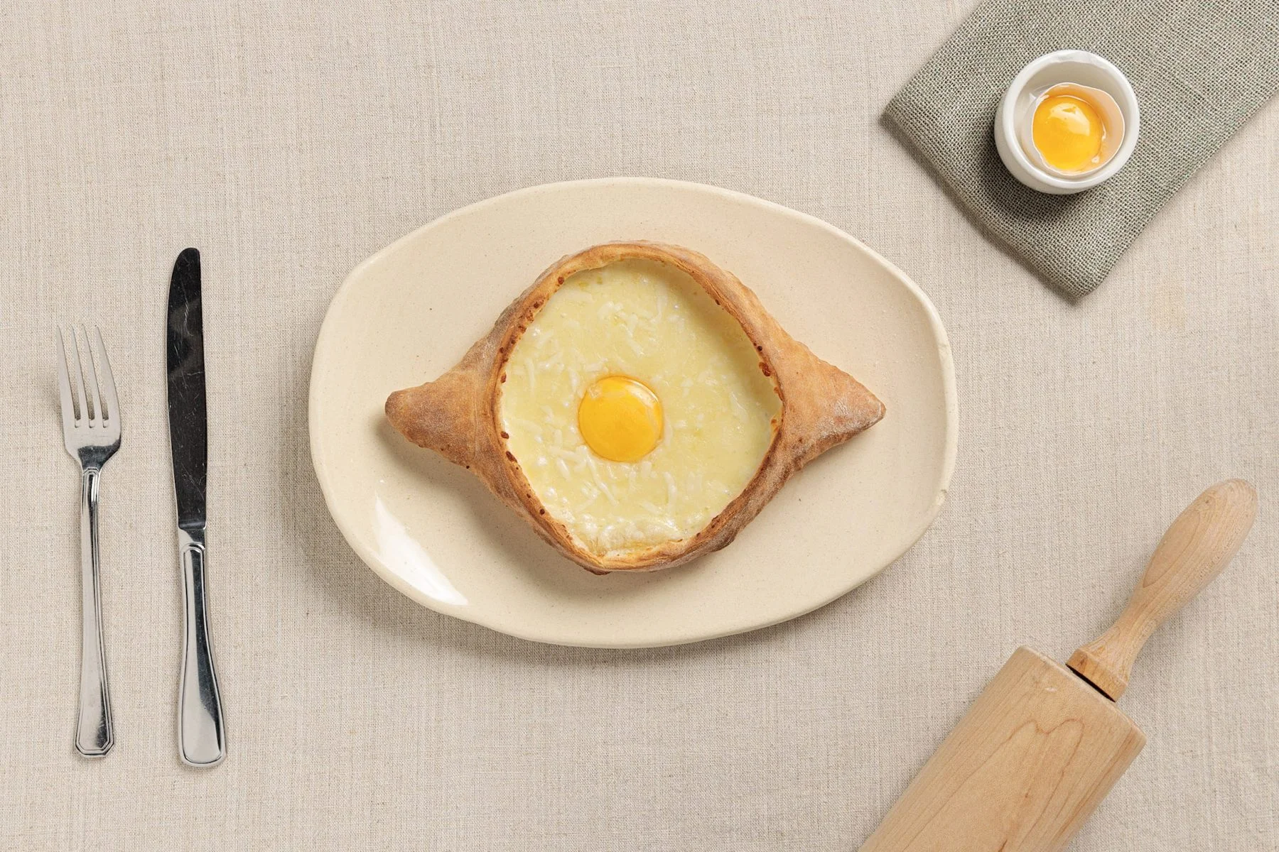 Adjaruli khachapuri served with cutlery
