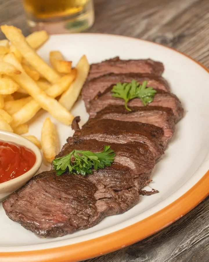 Grilled steak with fries and ketchup, a classic American dish