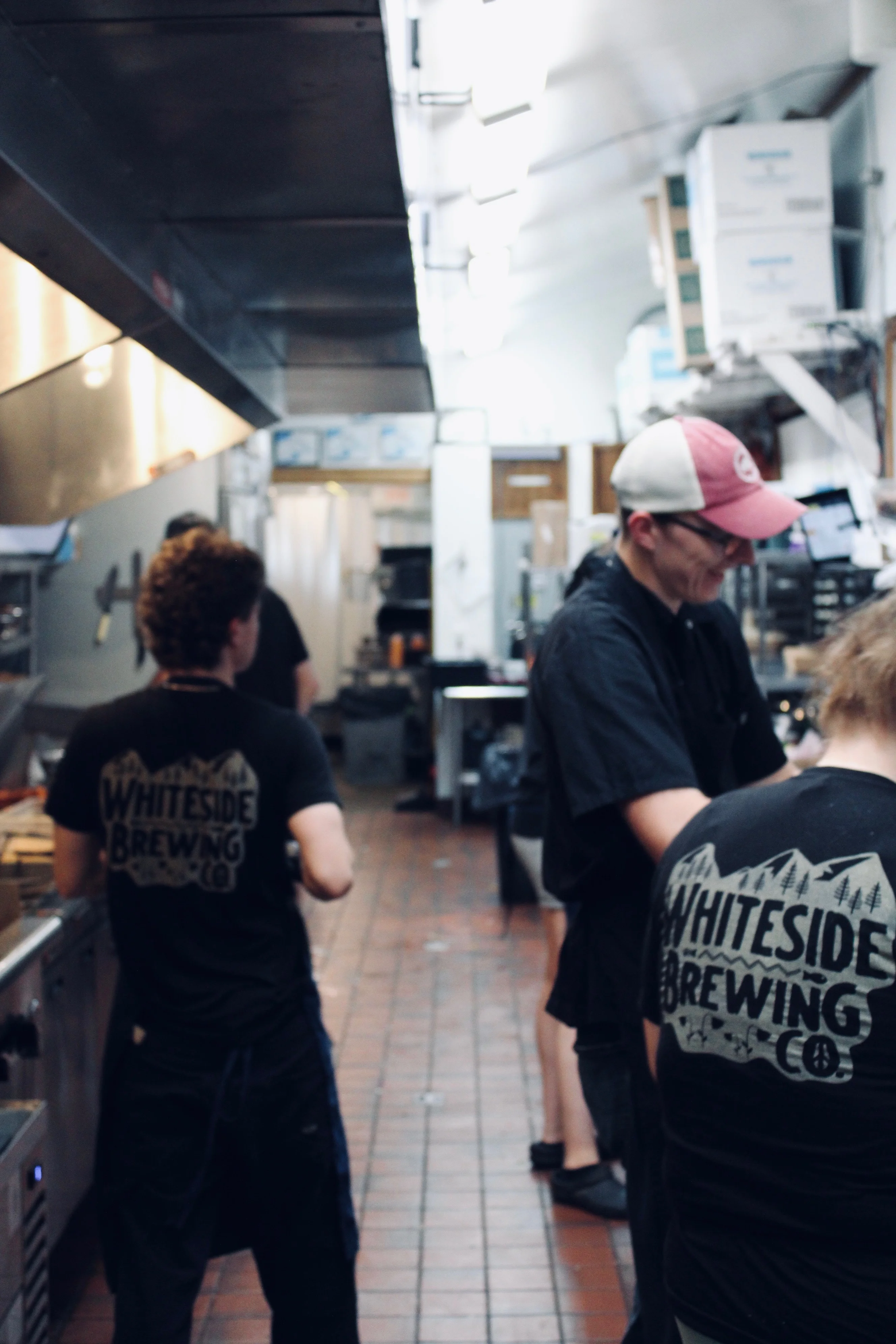 Busy restaurant kitchen with chefs preparing meals