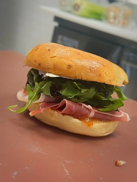 Delicious gourmet burger with fresh toppings on a wooden table