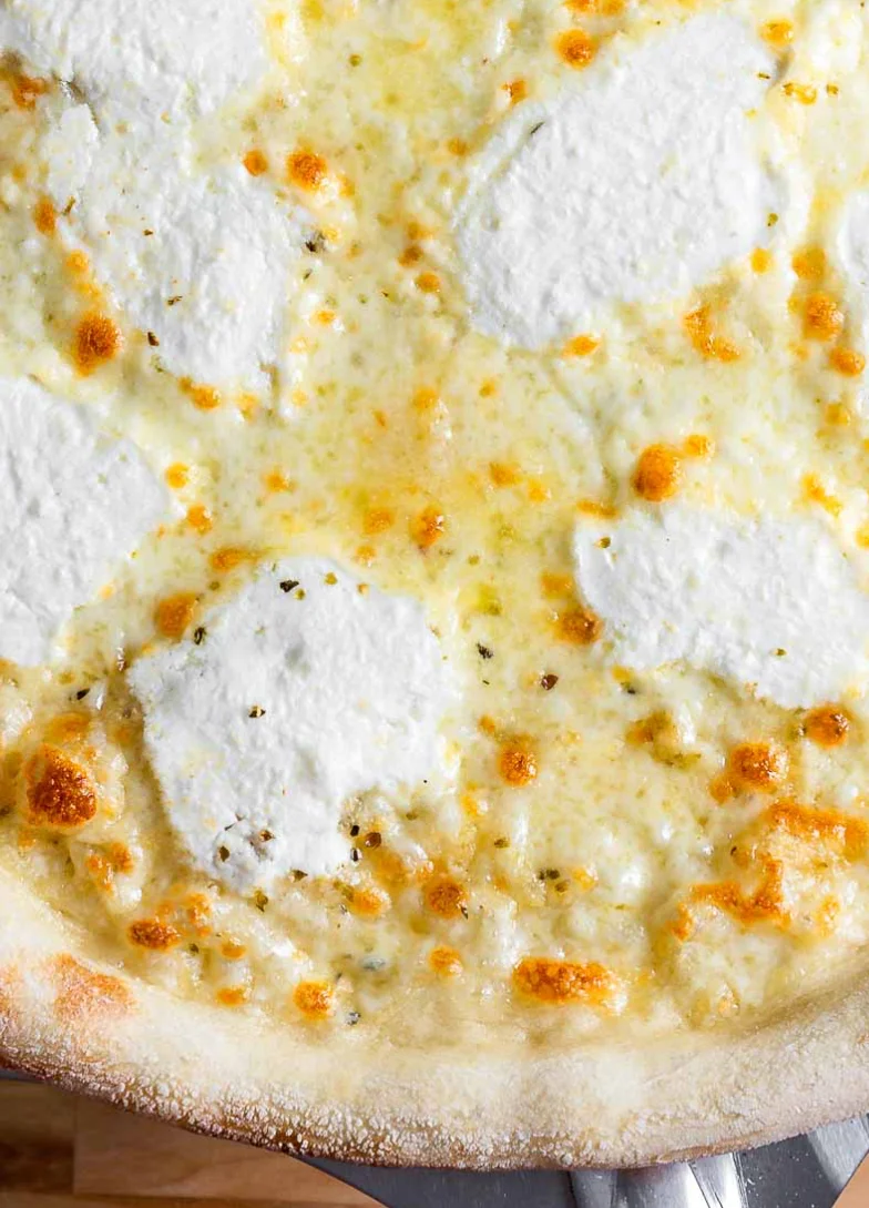 White pizza with ricotta cheese and golden crust