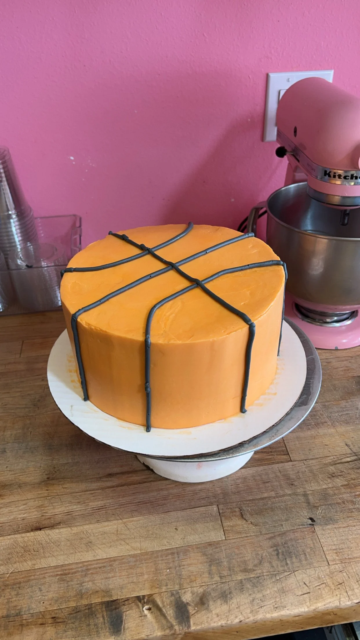 Basketball-themed cake with orange frosting and gray detailing