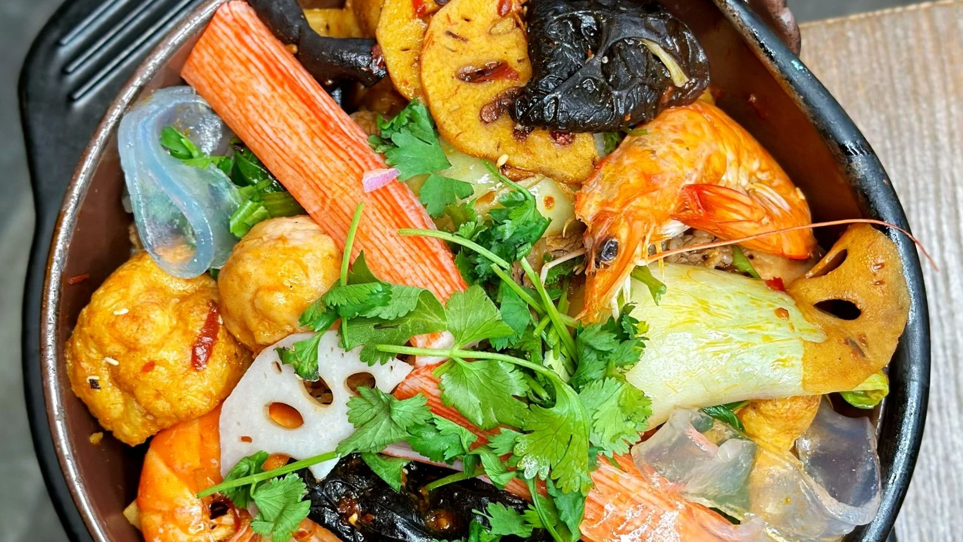 Spicy Chinese hot pot with seafood and vegetables