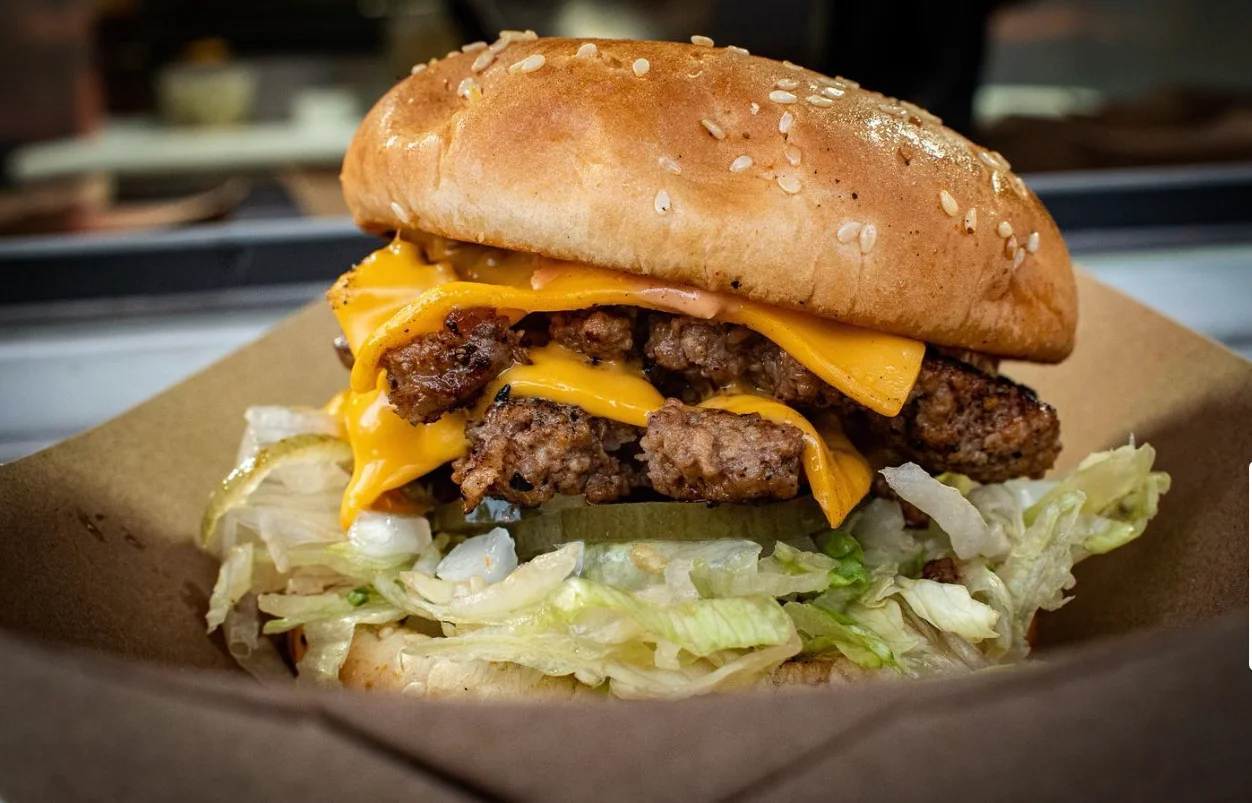 Juicy cheeseburger with crispy lettuce and sesame bun