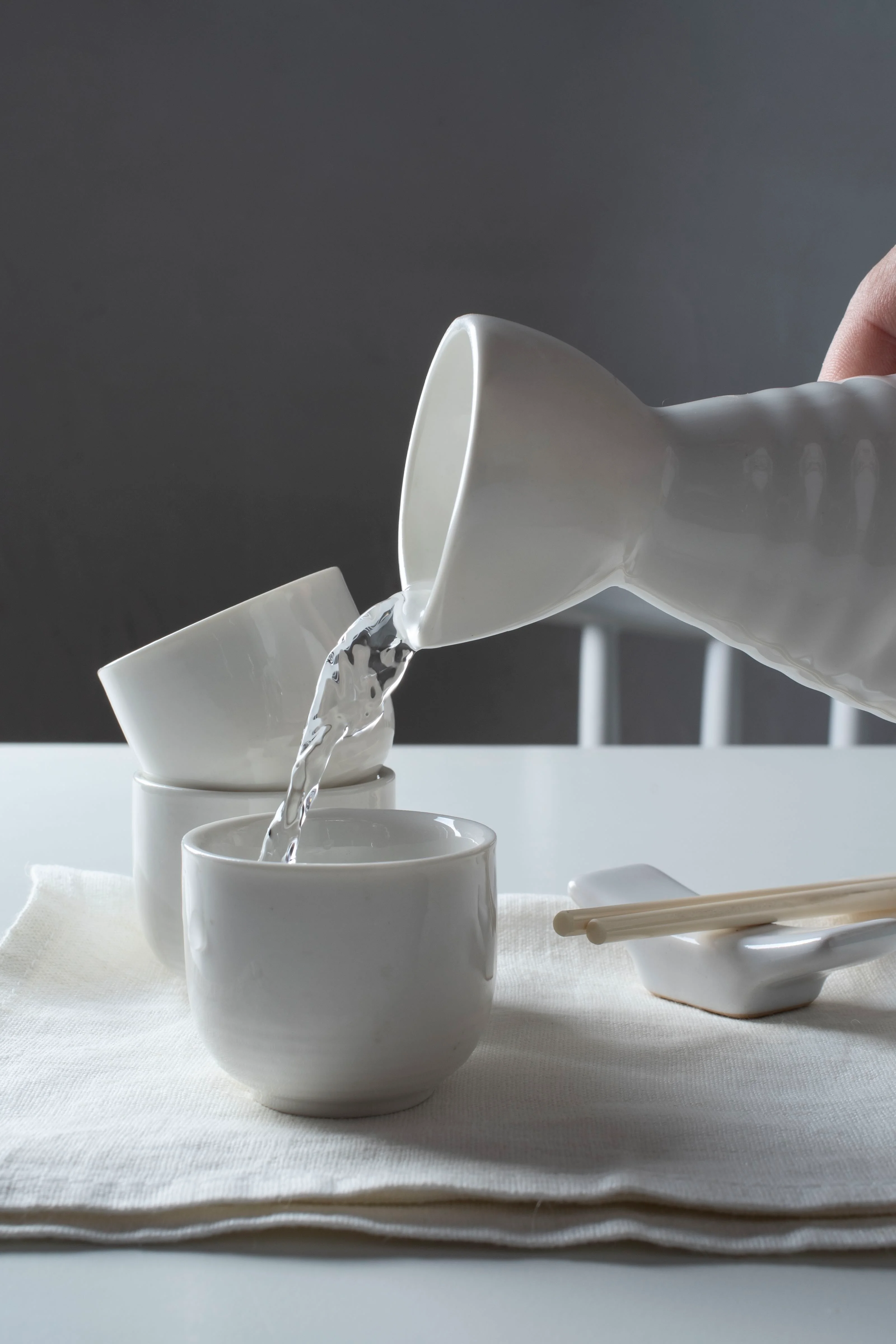 Pouring sake into traditional Japanese cups