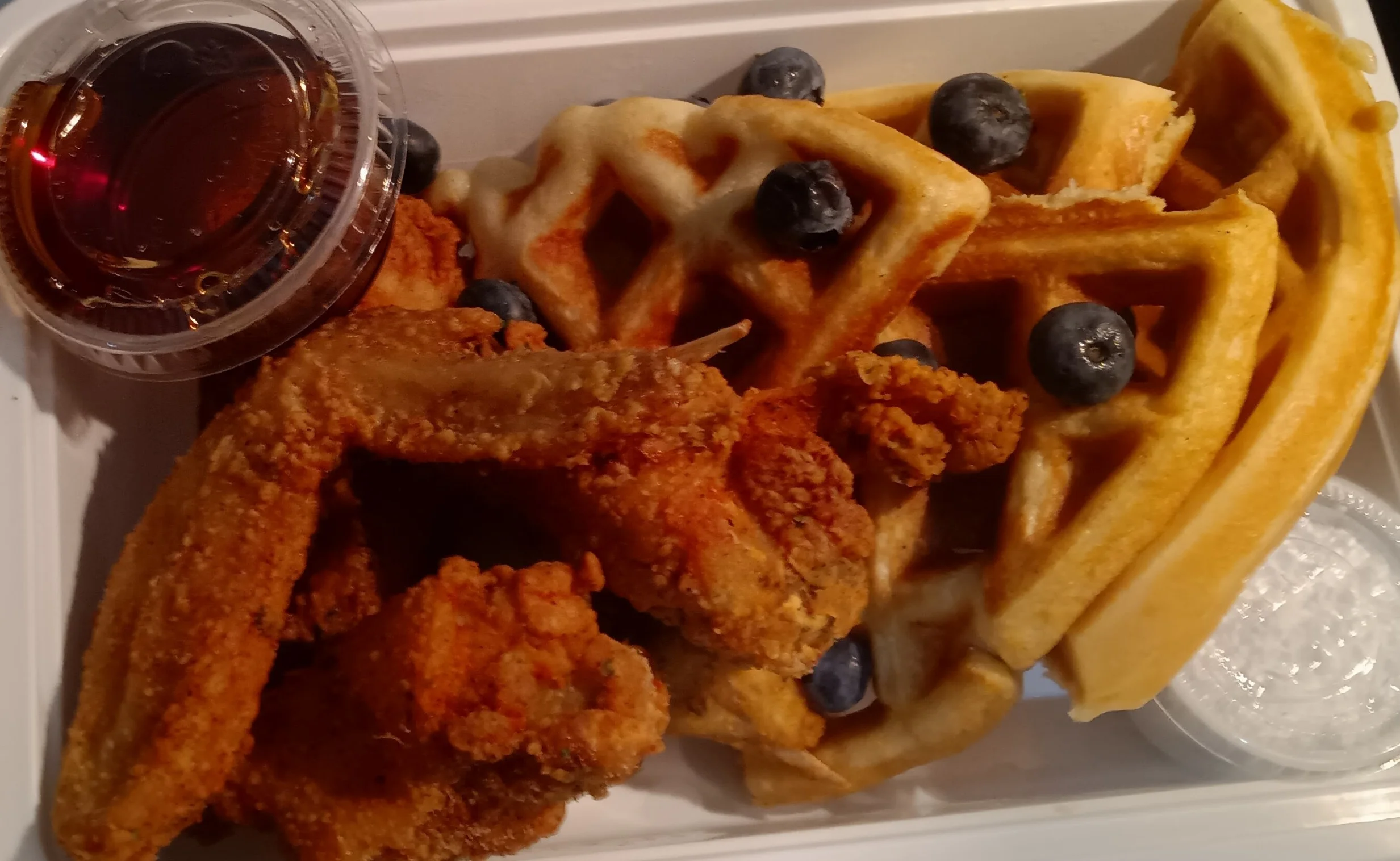 Southern chicken and waffles with syrup and blueberries