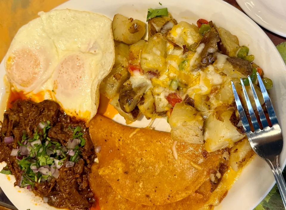 Traditional Mexican breakfast plate with eggs, beef, and potatoes