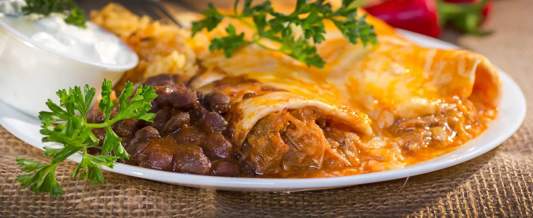 Delicious enchiladas with beans and sour cream, a classic Mexican dish