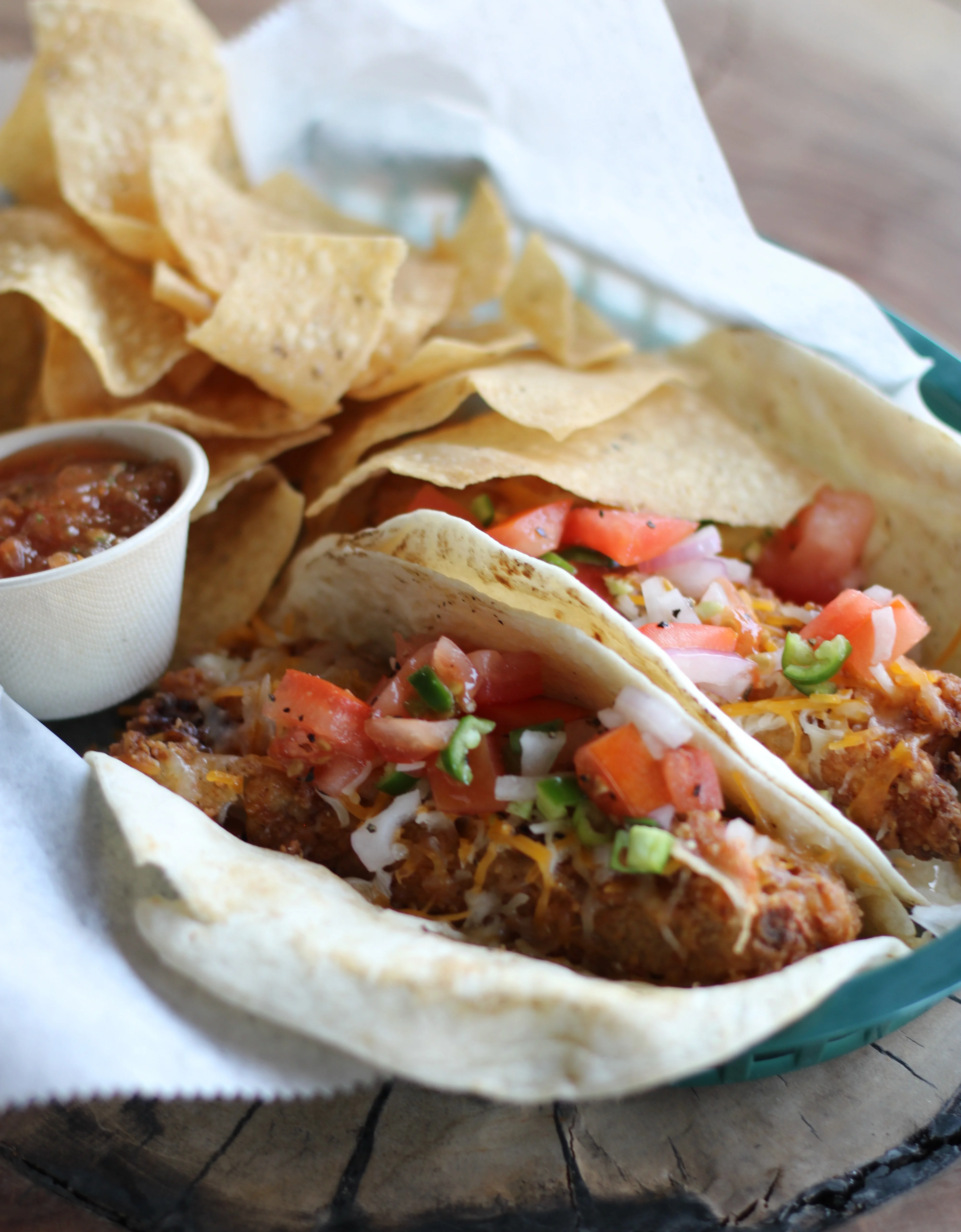 Delicious Mexican tacos with fresh toppings and tortilla chips on the side