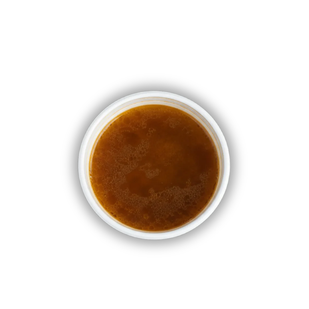 Rich Japanese dashi broth in a white bowl