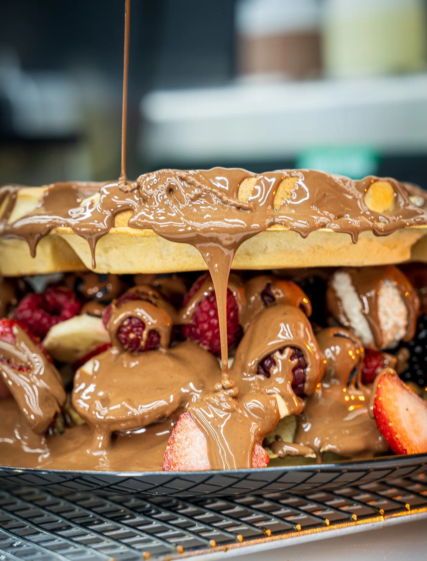 Decadent Belgian waffles topped with chocolate and fresh berries
