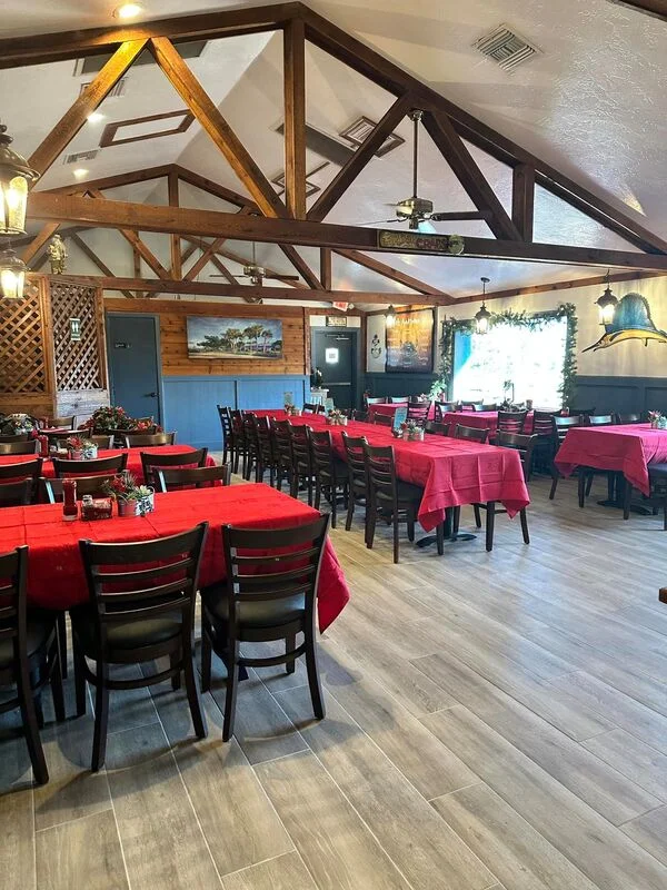 Cozy restaurant interior with red tablecloths and wooden beams