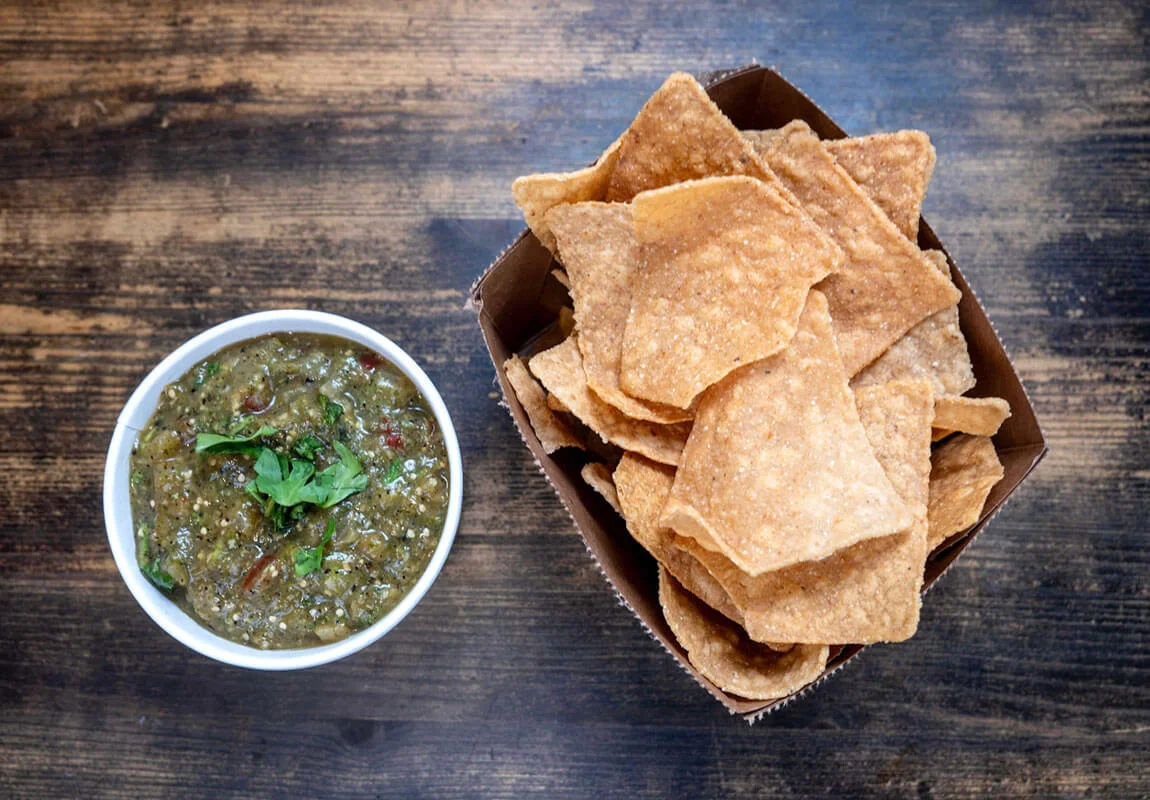 Bowl of salsa verde with tortilla chips
