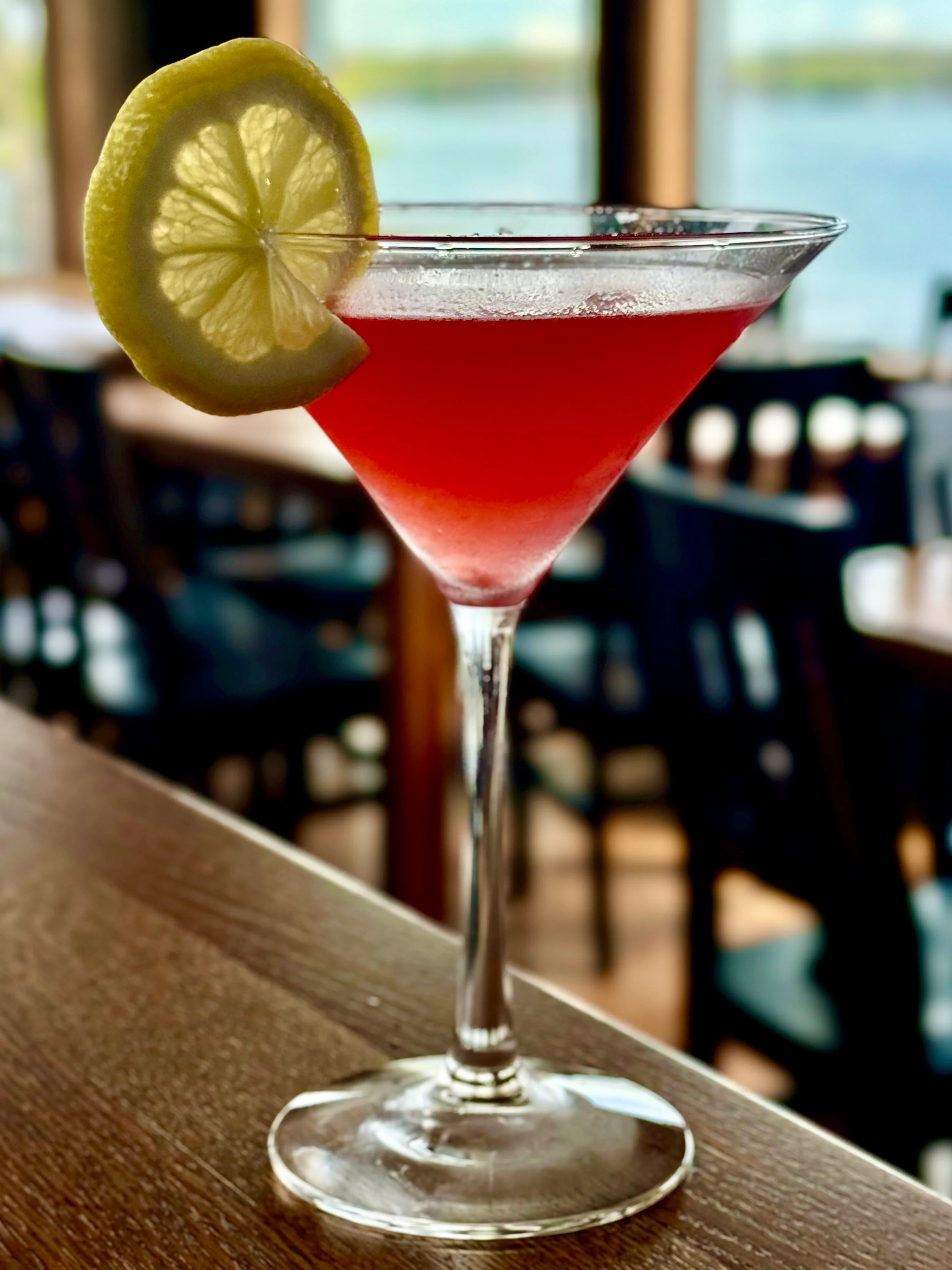 Vibrant cosmopolitan cocktail with lemon garnish