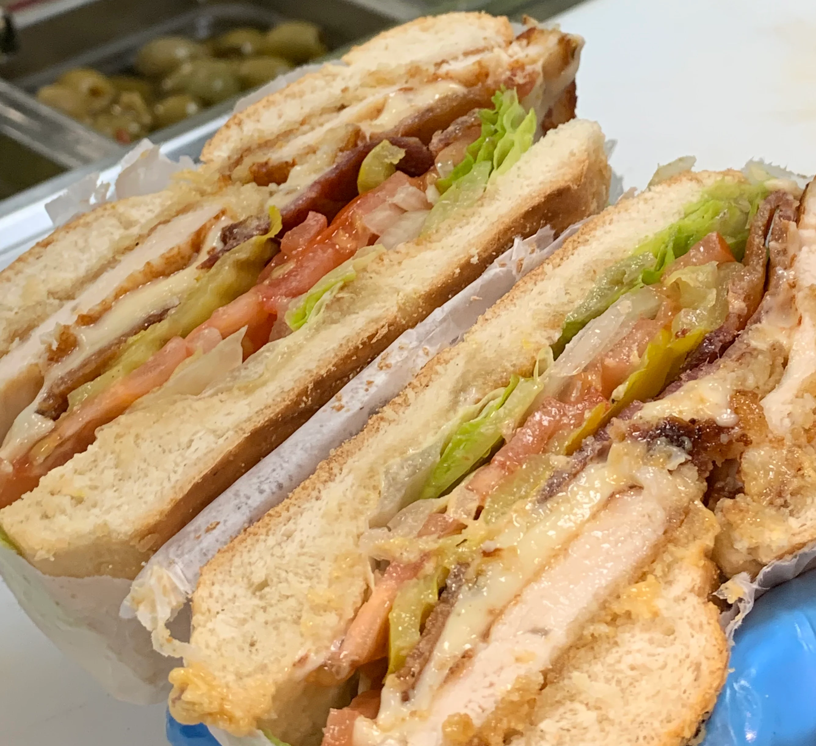 New York deli and grill logo featuring iconic Statue of Liberty design