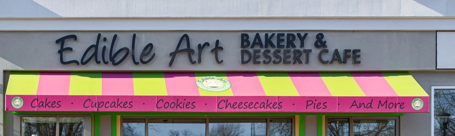Exterior of Edible Art Bakery & Dessert Cafe with colorful awning