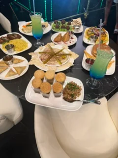 Assorted Indian dishes including samosas and biryani on a dining table