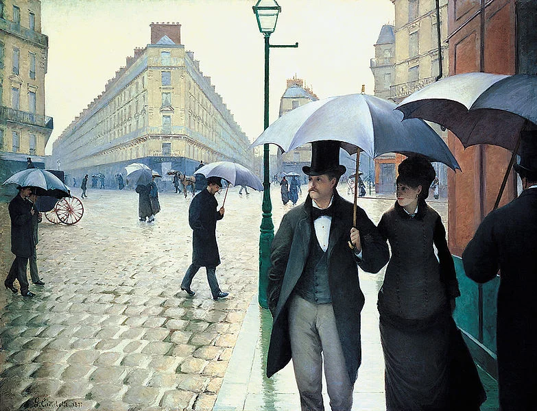 Rainy Paris street scene with people under umbrellas
