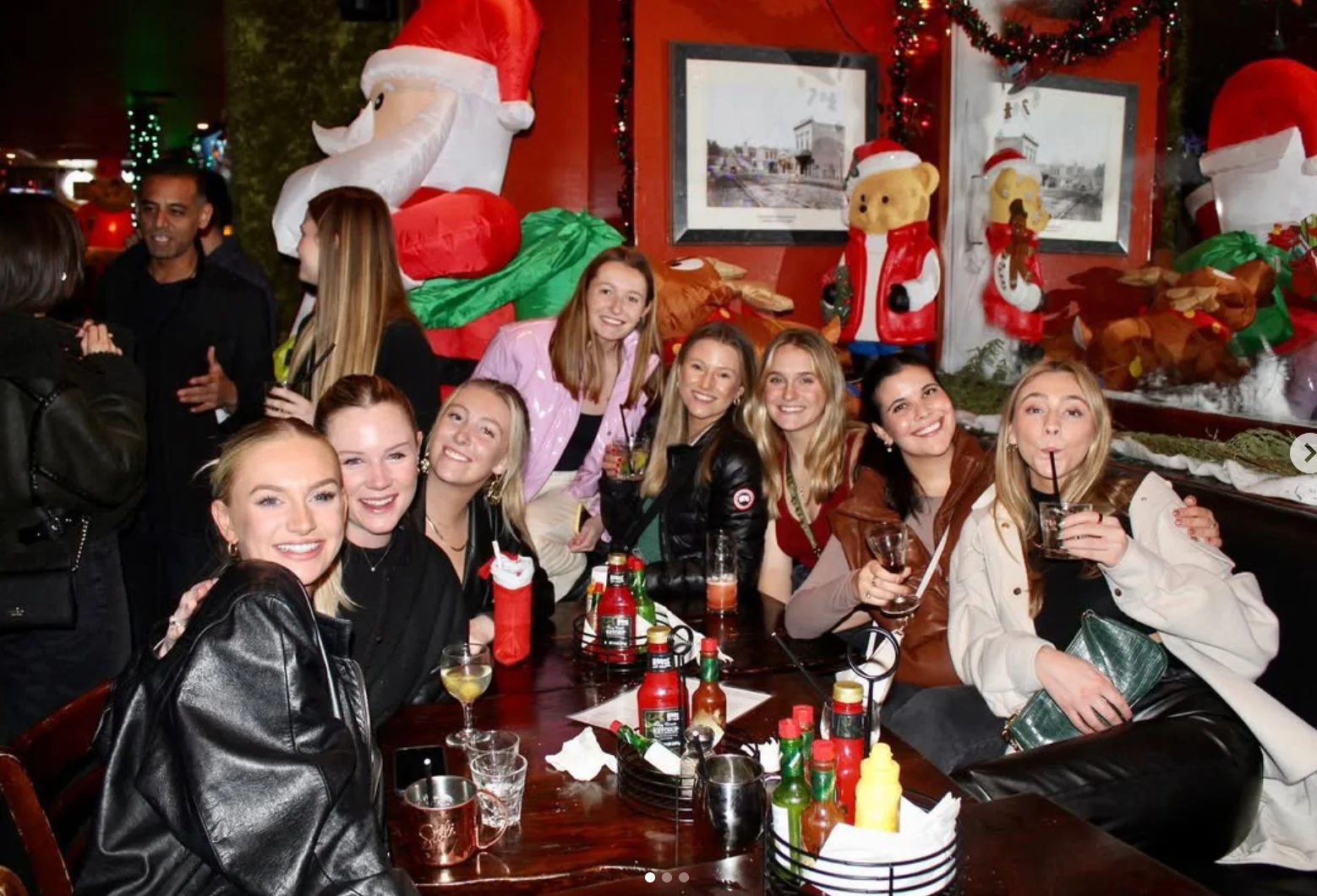 Group of friends enjoying drinks in a festive bar setting