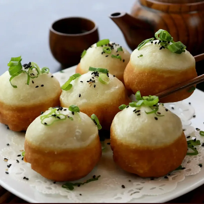 Chinese baozi with scallions and sesame seeds