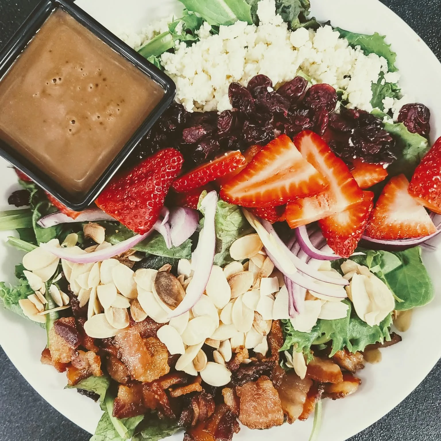 Fresh garden salad with strawberries and bacon