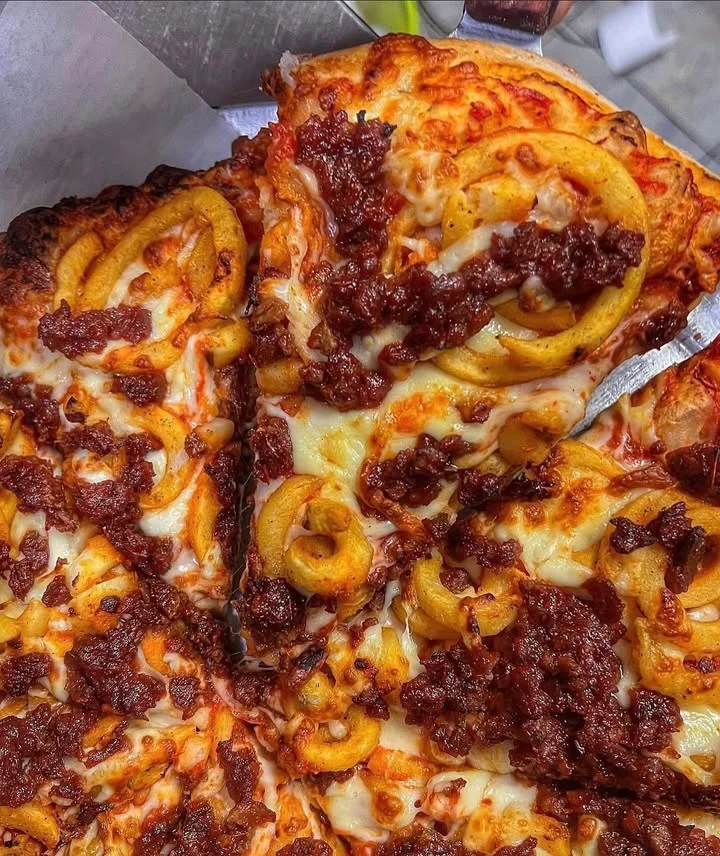 Savory pizza topped with chorizo and spiral fries