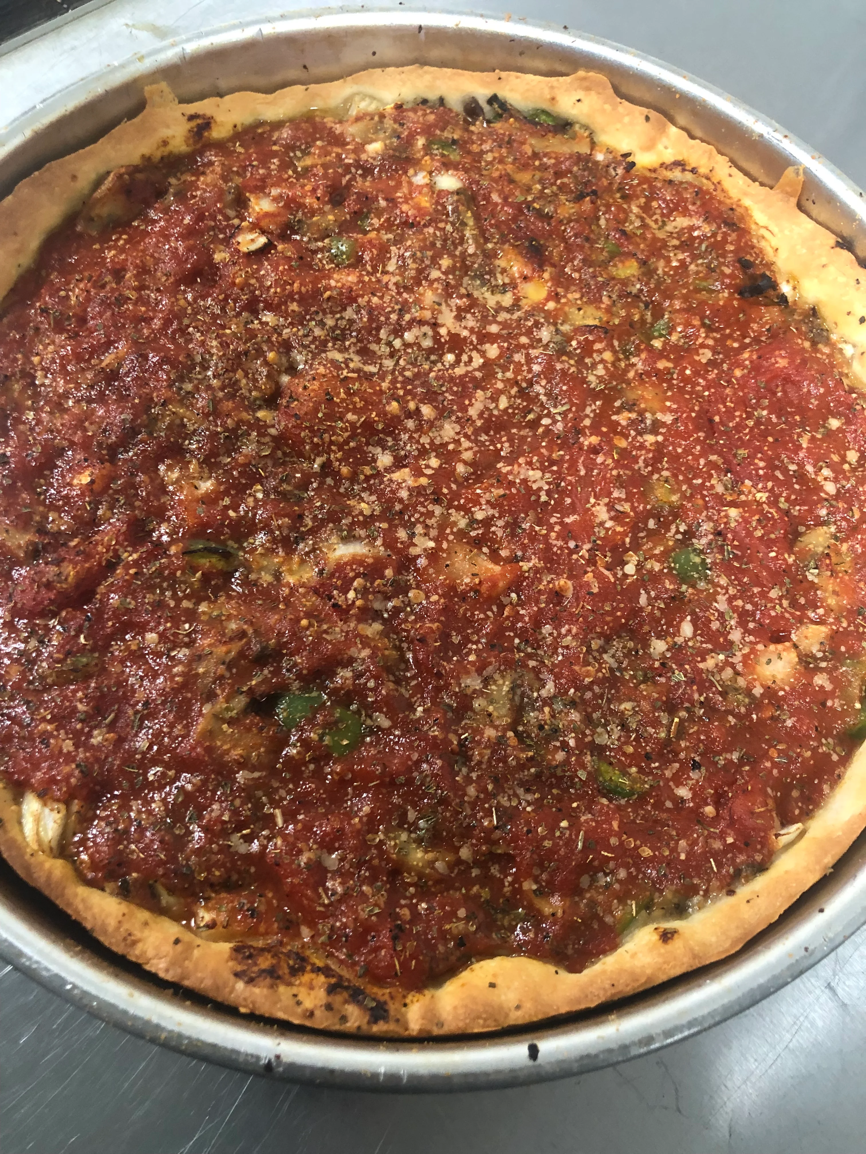 Deep-dish Chicago-style pizza with rich tomato sauce