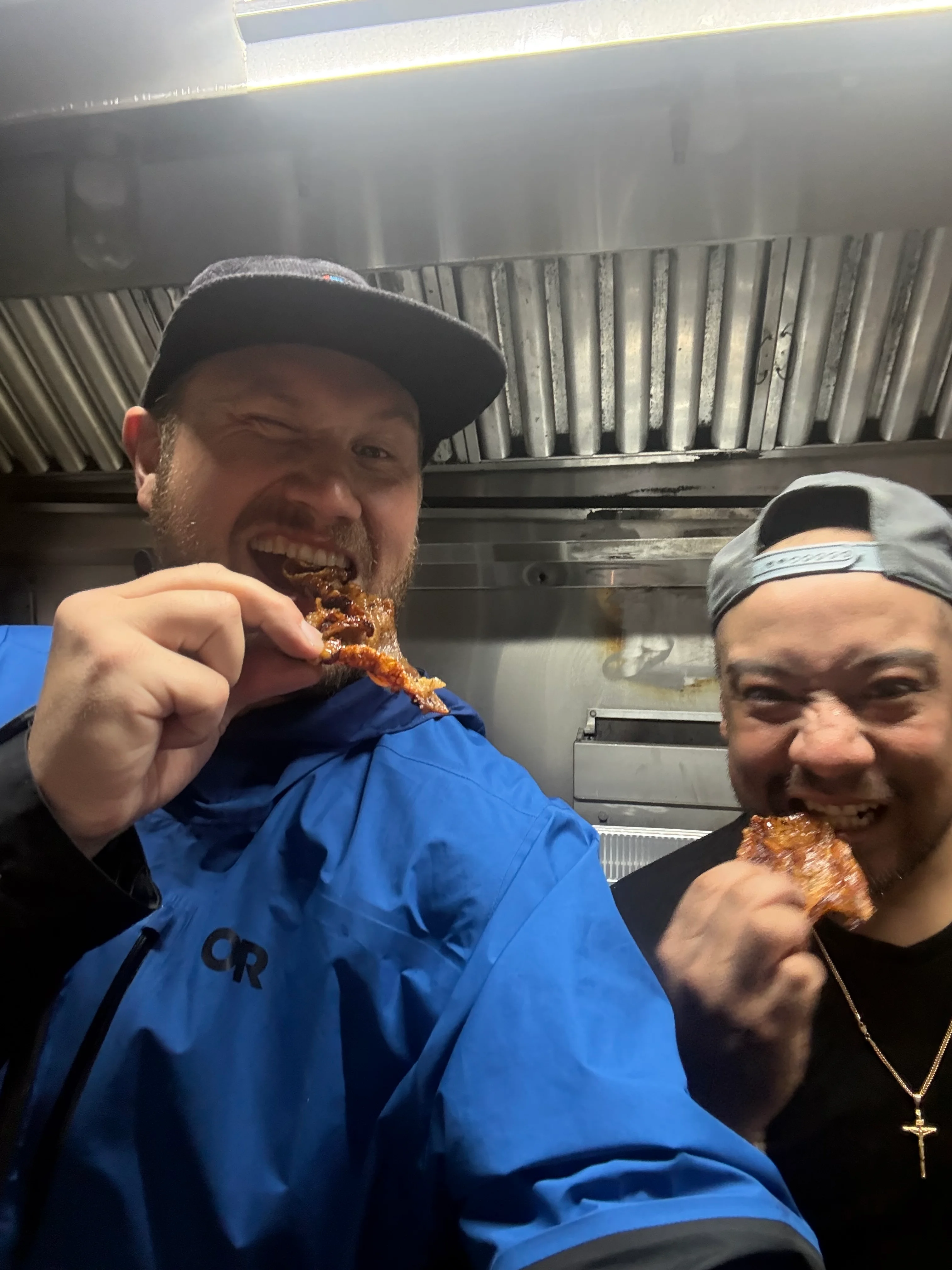 Chefs enjoying crispy fried chicken in a restaurant kitchen