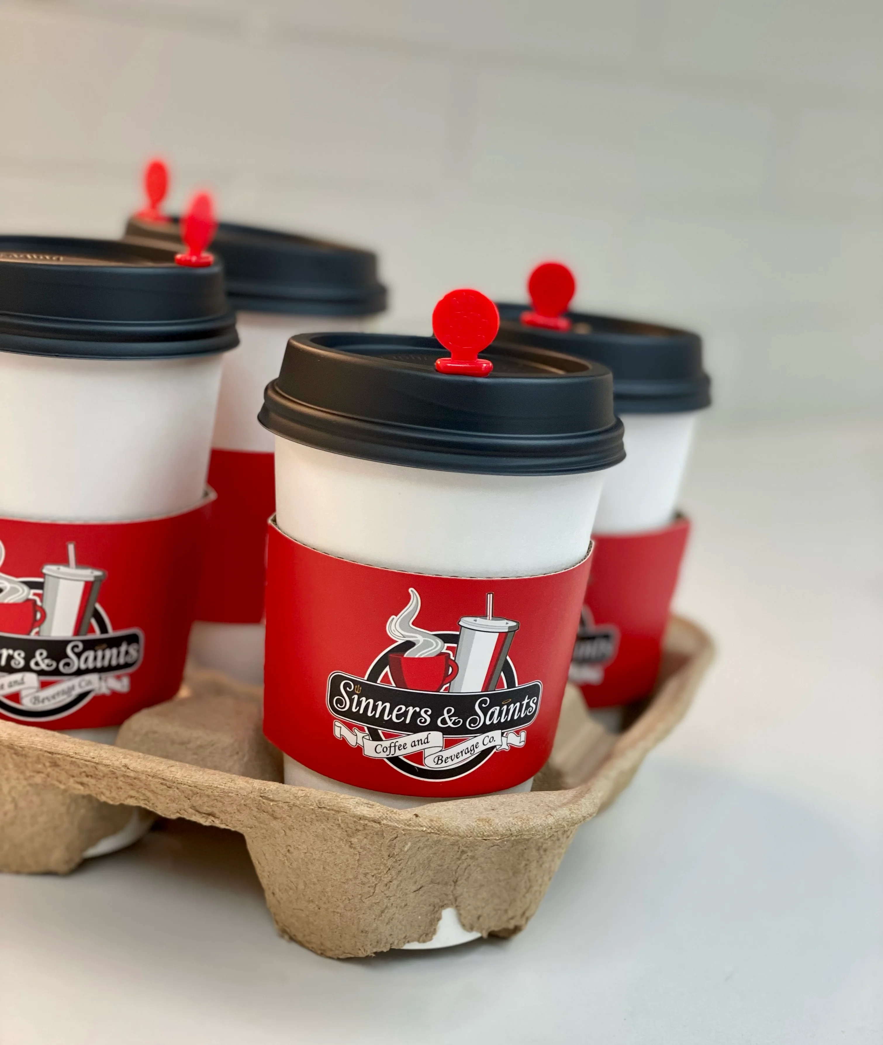 Coffee cups from Sinners & Saints Coffee and Beverage Co.