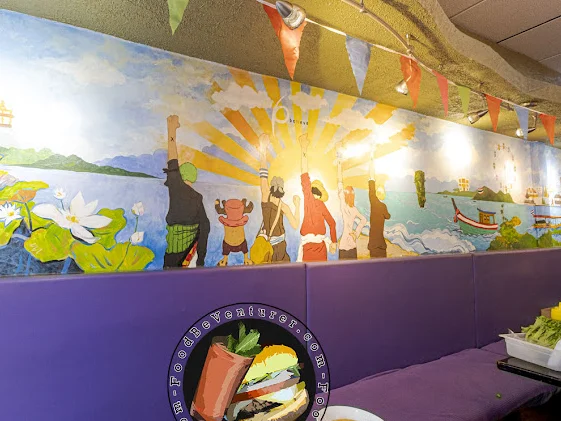 Vibrant mural depicting cultural scenes in a cozy restaurant