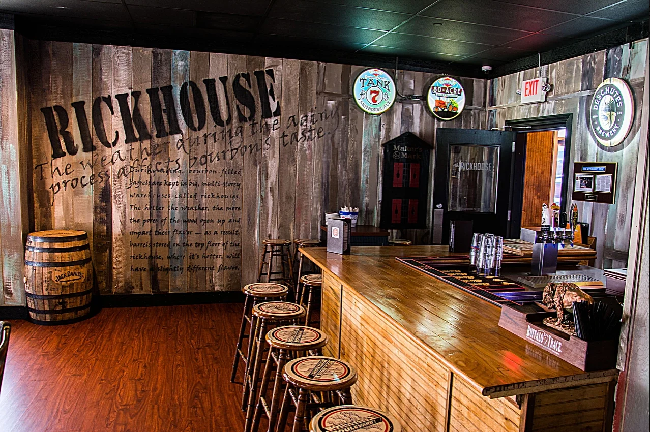 Rustic bar interior with wooden decor and bourbon barrels