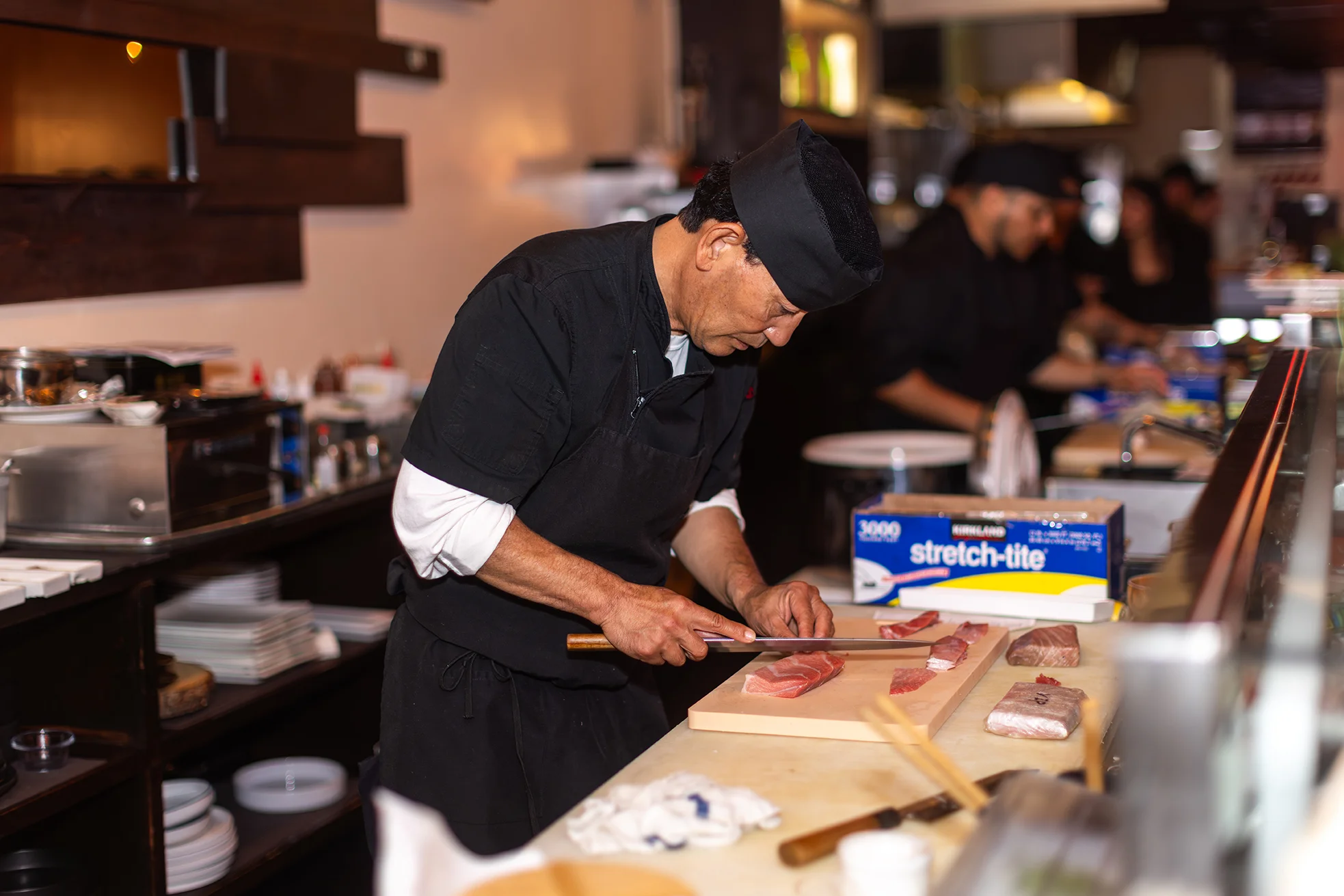A chief preparing freshly cut salmon