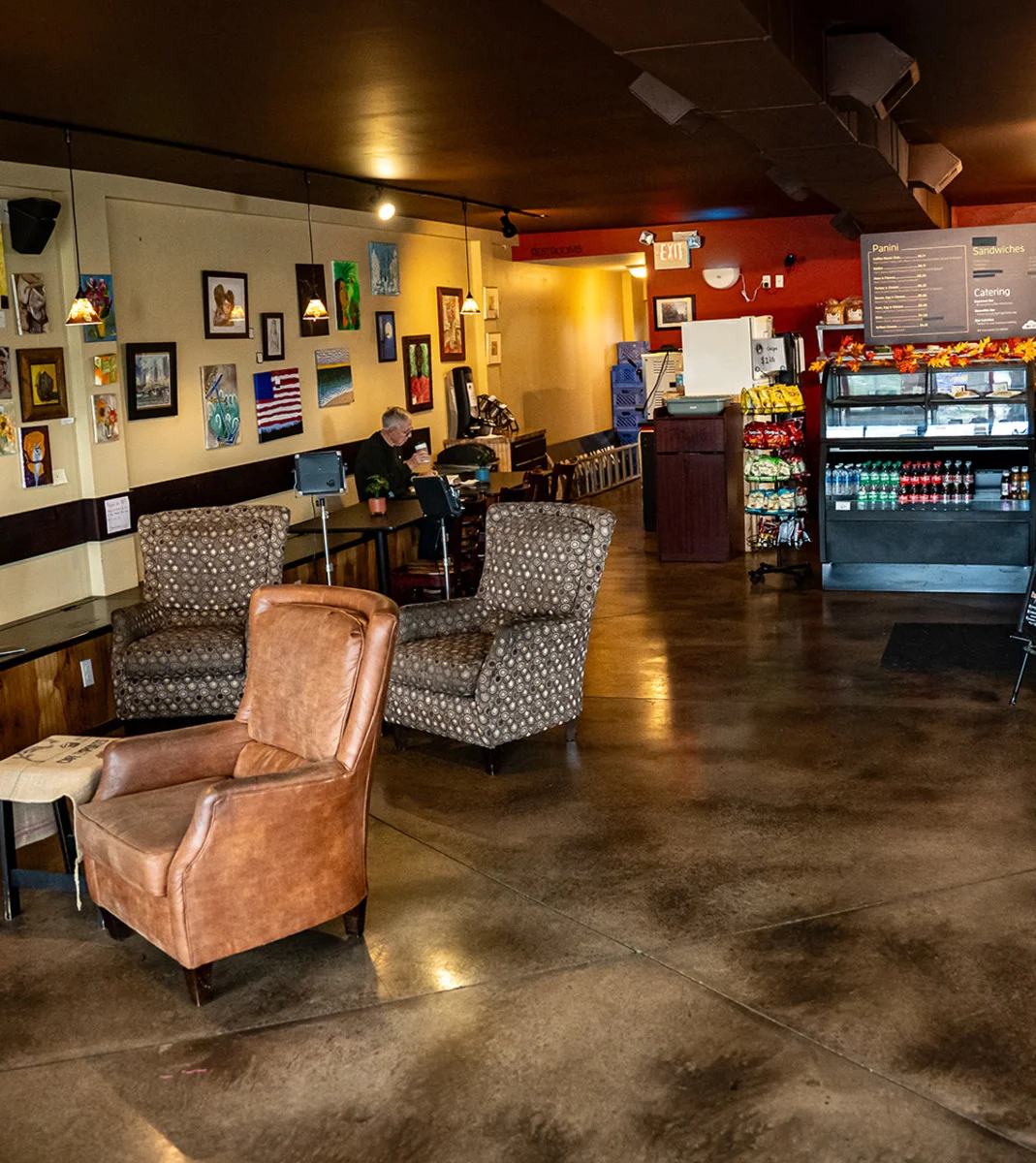 A coffee shop scene with images of cookies, sandwiches, and people engaging at the counter.