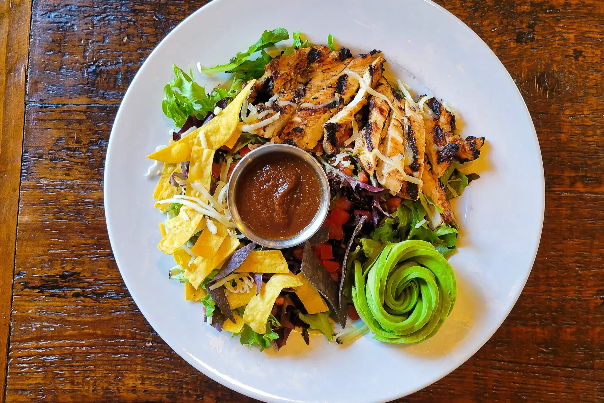 Grilled chicken salad with avocado and tortilla strips